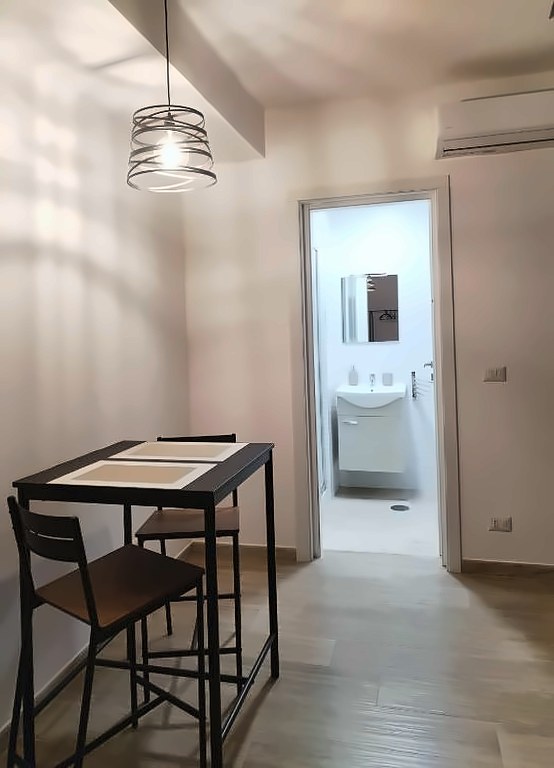 Zona pranzo con vista sulla porta del bagno e condizionatore